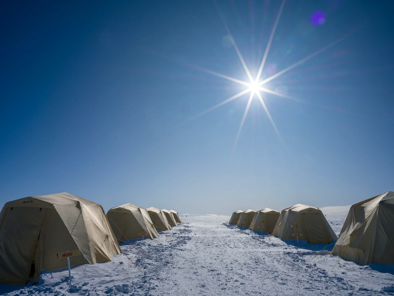 The sun shines brightly over guest tents at ALE's South Pole Camp