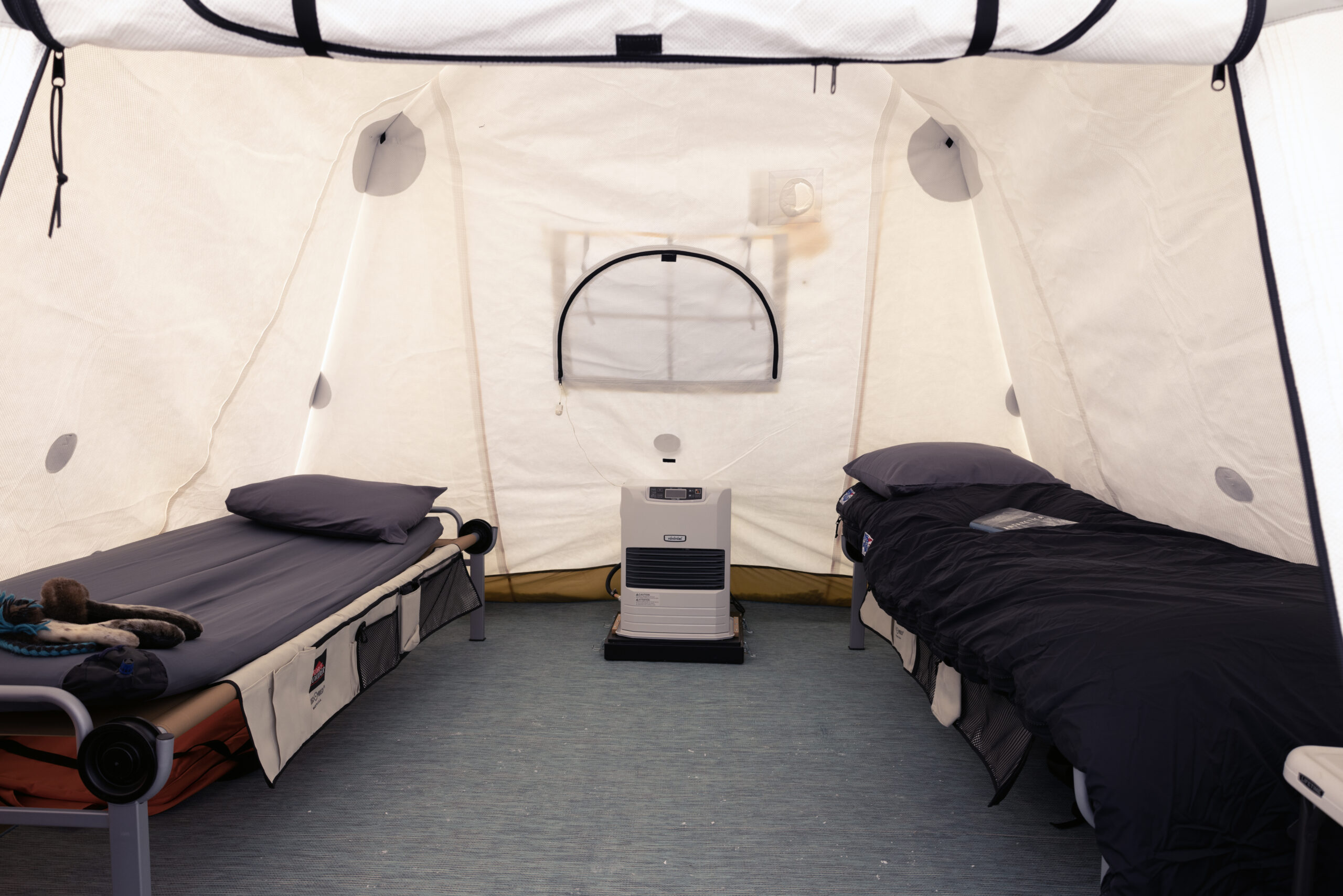 Each spacious tent is
outfitted with two comfortable cots, a table and a heater.